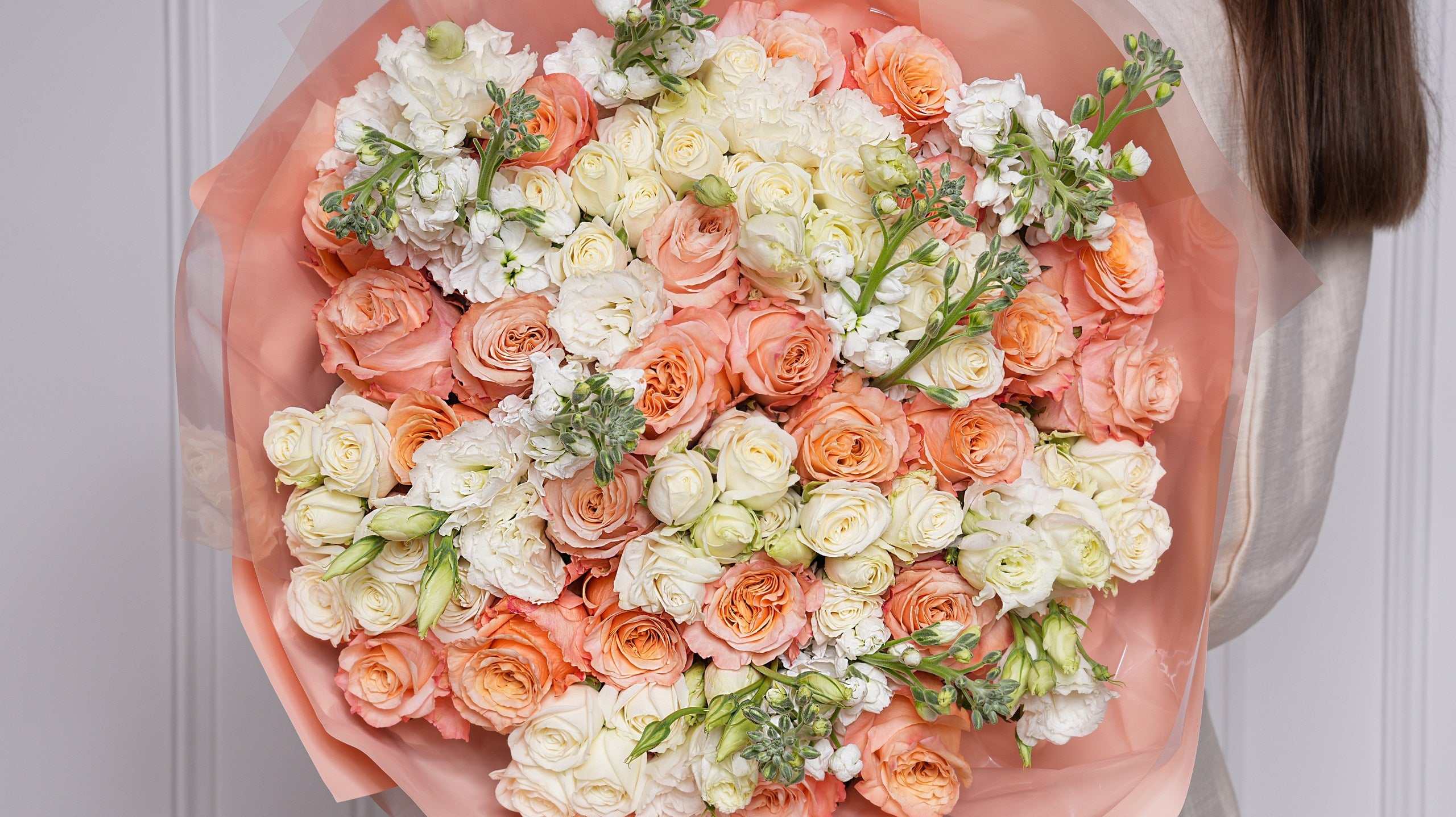Bright orange and coral summer rose bouquet hand-tied by Ecoroses, a Los Angeles florist