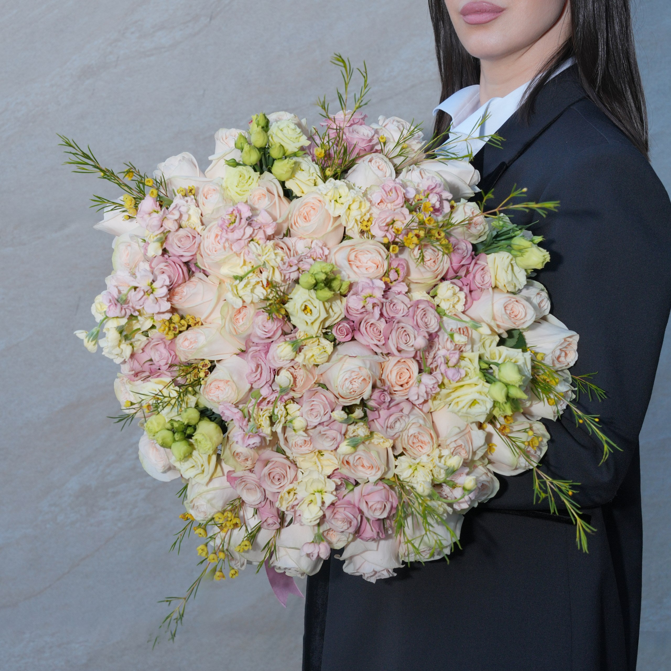 Mirabella luxury bouquet — peach Garden Spirit roses, star baby roses, yellow lisianthus, and stock in a hand-tied garden-style arrangement | Ecoroses Los Angeles