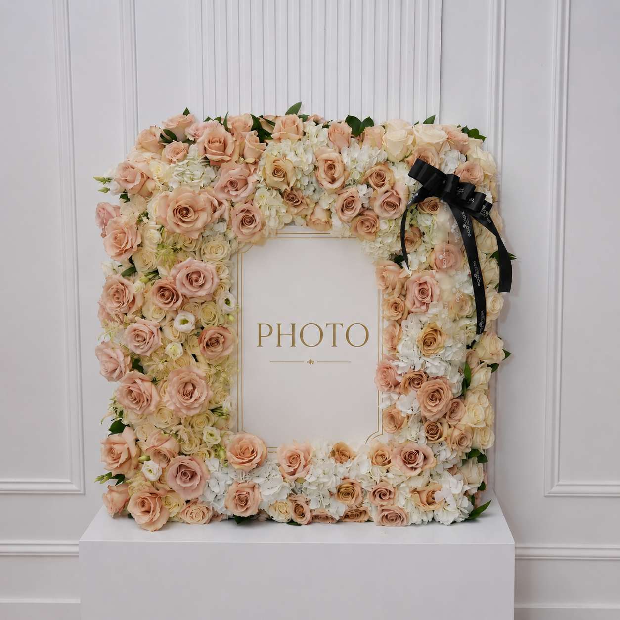 Memorial photo frame in champagne, blush, and cream roses with white hydrangea and lisianthus around a portrait window | Ecoroses Los Angeles