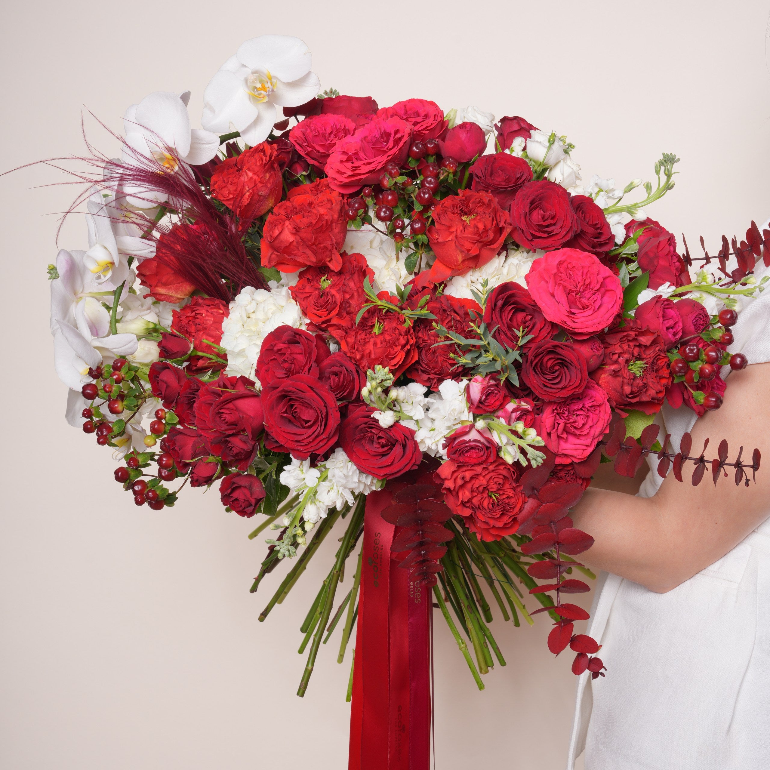 Cremisi luxury bouquet — Red Eye roses and red baby roses with white hydrangea, lisianthus, and a single orchid in a hand-tied arrangement | Ecoroses Los Angeles