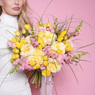 Ilaria couture bouquet — yellow and pink baby roses with garden roses, snapdragon, and bear grass in a bright hand-tied arrangement | Ecoroses Los Angeles