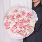 Flavia bouquet — fifty white Ohara garden roses with pink baby roses and feathered astilbe, hand-tied | Ecoroses Los Angeles