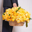 Amarilla arrangement — golden yellow roses and Catalina garden roses with cream baby roses in a woven basket | Ecoroses Los Angeles