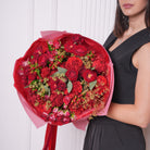 Gia couture bouquet — deep red Red Eye roses with red baby roses, coffee bean foliage, and seeded eucalyptus, hand-tied | Ecoroses Los Angeles